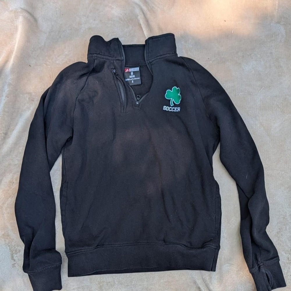 Black quarter zip sweatshirt with green shamrock